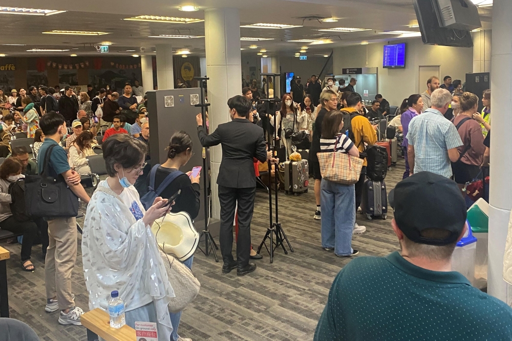 This UGC photo taken on February 7, 2024 and posted by Facebook user Watcharapon Pethsurp on February 9 shows passengers waiting at Chiang Mai Airport in Chiang Mai, after disembarking their flight following a passenger’s attempt to open an emergency exit door. — AFP pic/Courtesy of Facebook user Watcharapon Pethsurp