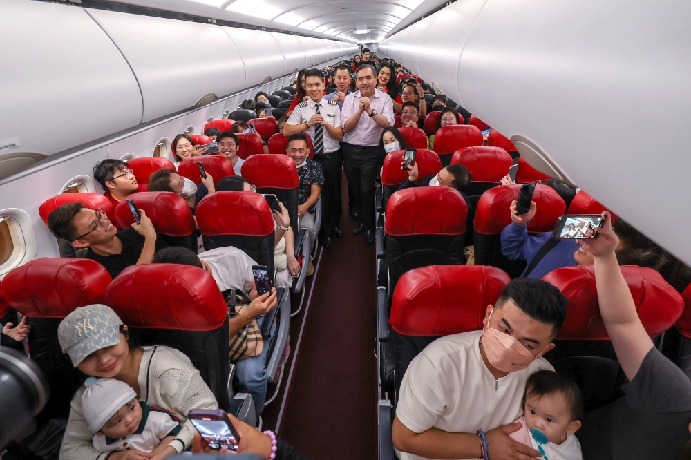 Transport Minister Anthony Loke conveying his Lunar New Year wishes to AirAsia passengers in KLIA2 in Sepang February 7, 2024. — Bernama pic 