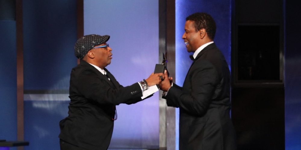 Filmmaker Spike Lee presenting actor Denzel Washington with his Life Achievement Award on stage during the 47th American Film Institute (AFI) Life Achievement Award Gala at the Dolby theatre in Hollywood on June 6, 2019. — AFP file pic