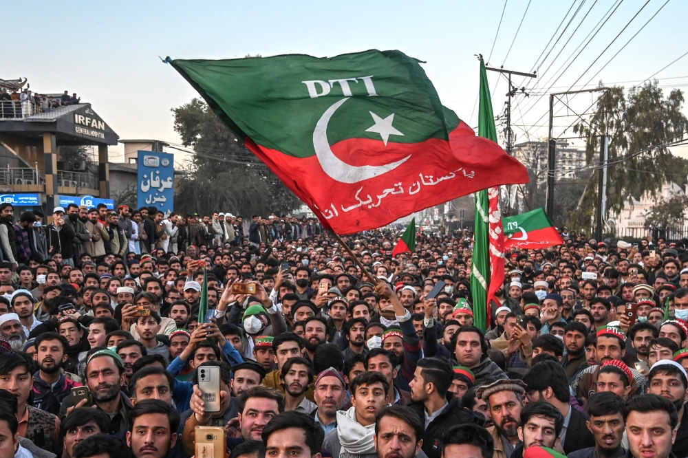 Supporters of Pakistan Tehreek-e-Insaf (PTI) party protest outside the office of a Returning Officer in Peshawar on February 9, 2024, against the alleged rigging in Pakistan's national election results. — AFP pic