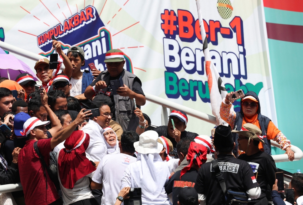 Supporters gather around Presidential candidate Anies Baswedan for taking pictures, during his campaign rally at the Jakarta International Stadium in Jakarta, Indonesia, February 10, 2024. — AFP pic