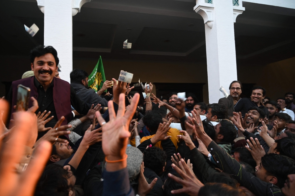 Supporters of Pakistan’s former Prime Minister Nawaz Sharif (not in the picture) and leader of the Pakistan Muslim League Nawaz(PMLN) party, gather at the headquarter of PMLN office a day after Pakistan's national elections, in Lahore on February 9, 2024. — AFP pic