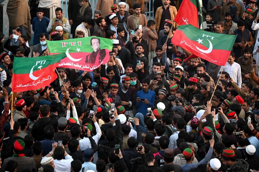 Supporters of Pakistan Tehreek-e-Insaf (PTI) party protest outside the office of a Returning Officer in Peshawar on February 9, 2024, against the alleged rigging in Pakistan's national election results. — AFP pic