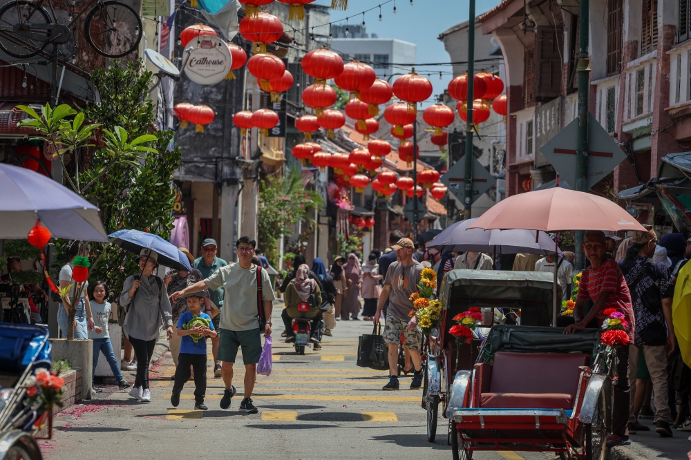 People, especially visitors from abroad, spend their free time with family and friends in conjunction with the Chinese New Year public holiday at Lebuh Armenian, George Town, February 10, 2024. — Bernama pic