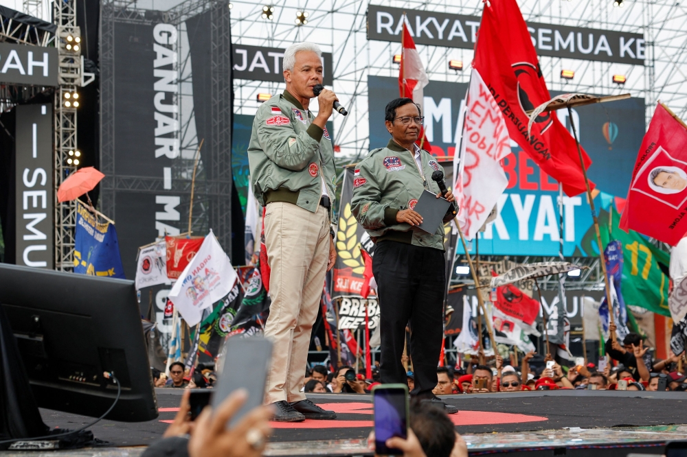 Ganjar Pranowo (left), presidential candidate of the ruling Indonesian Democratic Party of Struggle (PDI-P) with his running mate Mahfud MFD at a campaign rally in Java. — Reuters pic