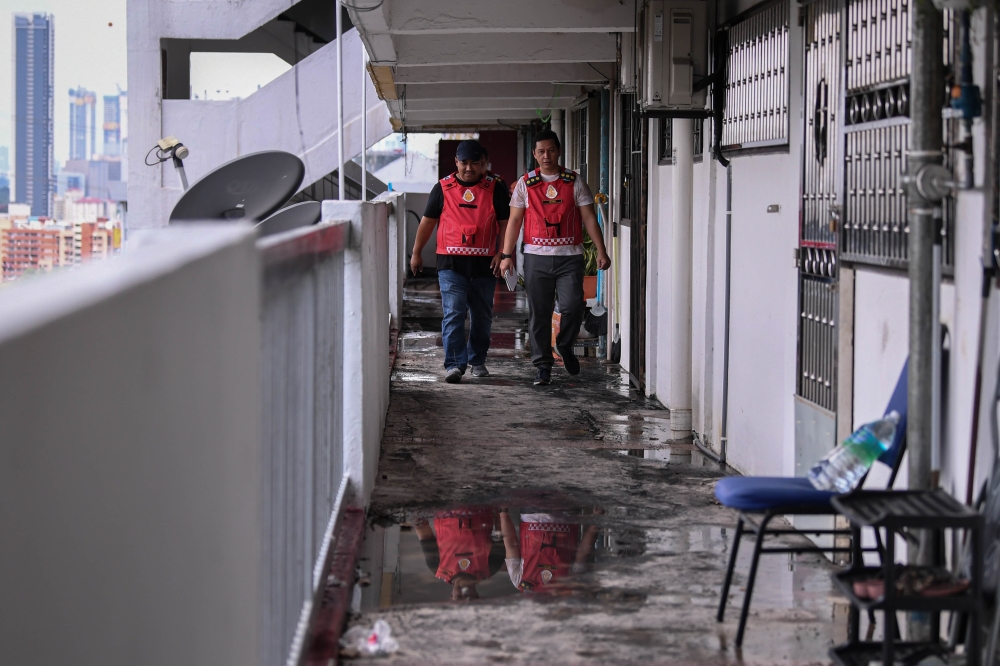The Malaysian Fire and Rescue Department personnel are seen after five units on the 17th floor of Block 70 of the Sri Sabah flats in Cheras were destroyed in a fire February 12, 2024. — Bernama pic