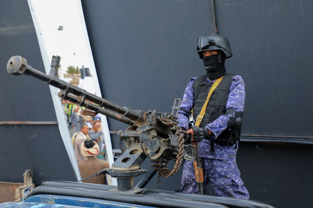 A member of Huthi-affiliated security forces mans a gun as he stands guard during a rally in the Huthi-run capital Sanaa on February 9, 2024 in support of Palestinians amid ongoing battles between Israel and the militant Hamas group in the Gaza Strip. — AFP pic