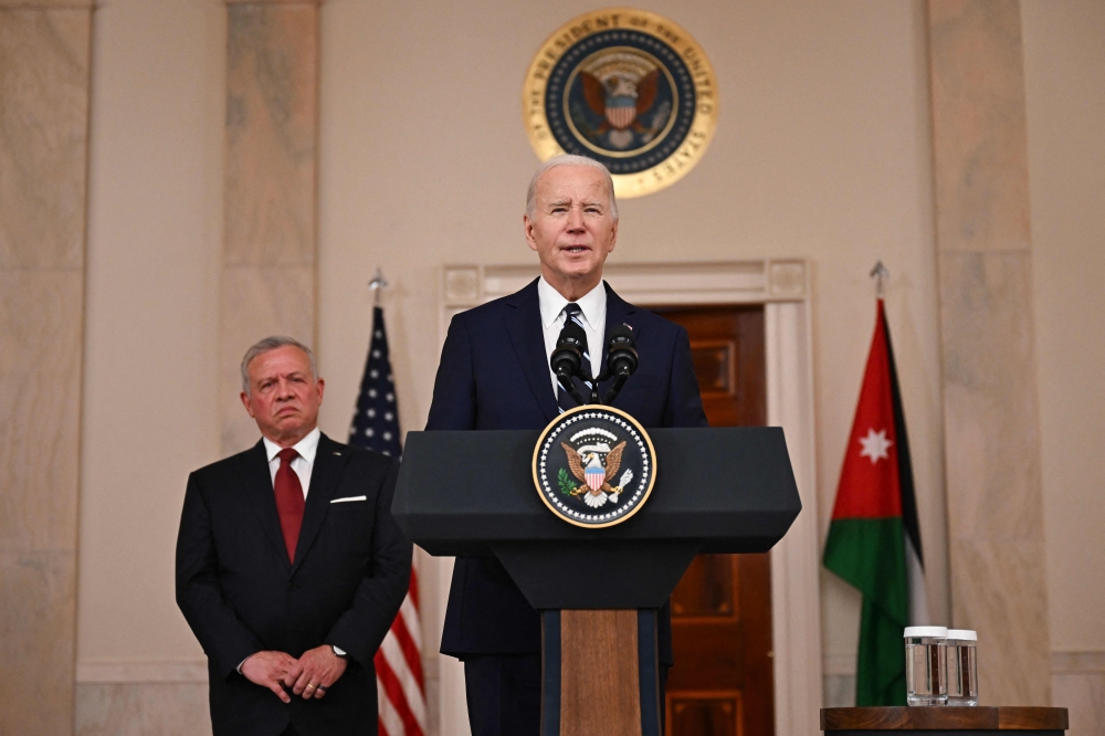 US President Joe Biden speaks as King Abdullah II of Jordan listens in the Cross Hall of the White House in Washington, DC, on February 12, 2024. ― AFP pic