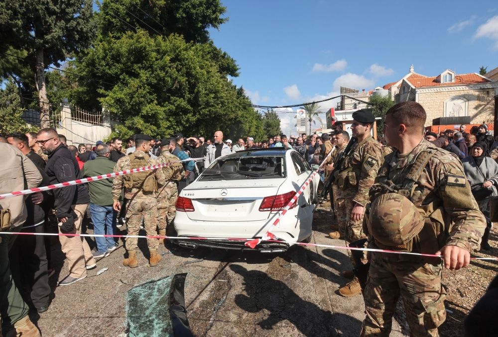 Members of the Lebanese army gather near a damaged vehicle in the aftermath of what security sources said was an Israeli strike, in Jadra, Lebanon February 10, 2024. ― Reuters pic