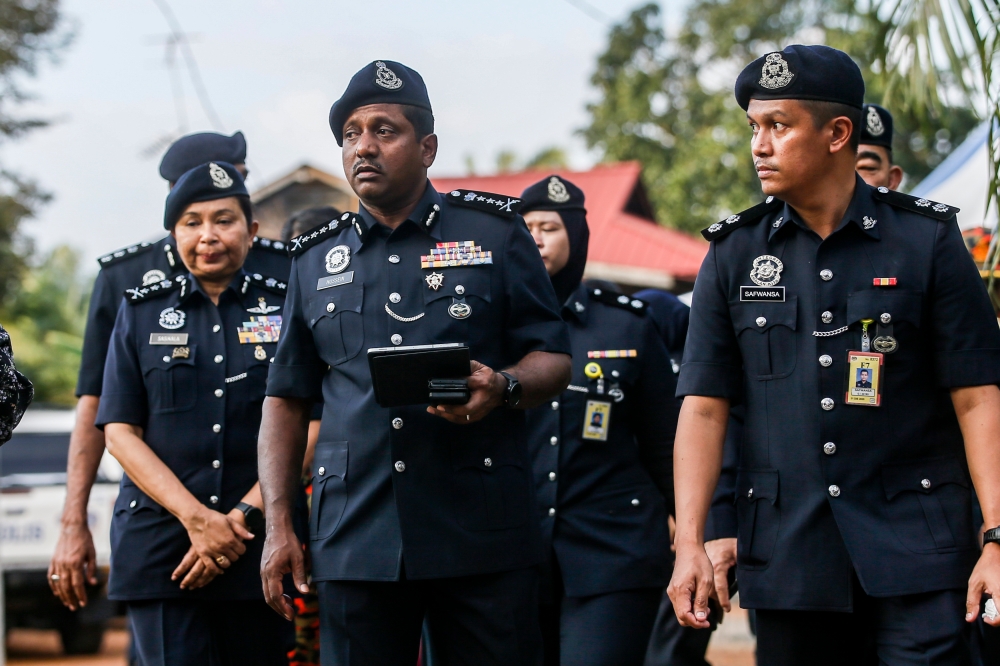 Selangor police chief Datuk Hussein Omar Khan (centre) is seen at the location at the location where a light aircraft had crashed at Kapar, Selangor February 13, 2024. — Picture by Hari Anggara