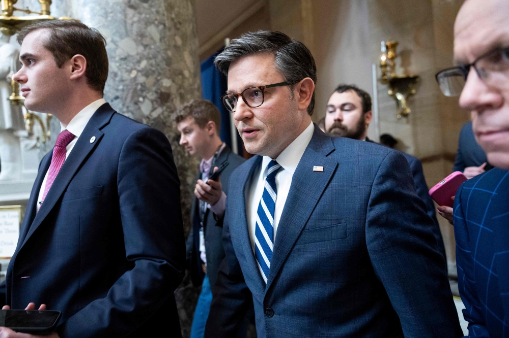 US Speaker of the House Mike Johnson talks to reporters as he returns to his office at the U.S. Capitol on February 13, 2024 in Washington, DC. — AFP pic