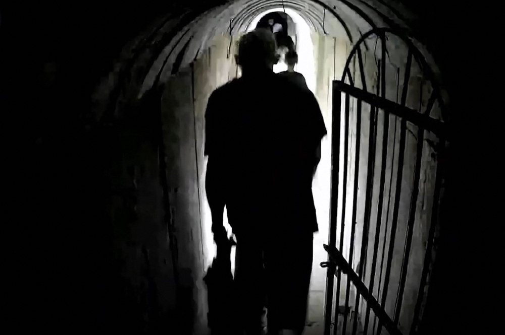 This image grab from a handout video released by the Israeli army on February 13, 2024, shows what the army says is Hamas' chief in Gaza Yahya Sinwar, walking in a tunnel along with other people, in the Gaza Strip amid ongoing battles between Israel and the Palestinian militant group Hamas. — AFP pic