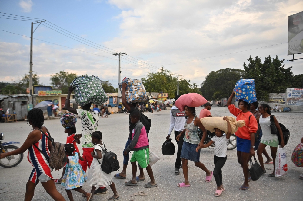 People flee gang violence in the Petion-ville neighborhood of Port-au-Prince on January 30, 2024. — AFP pic