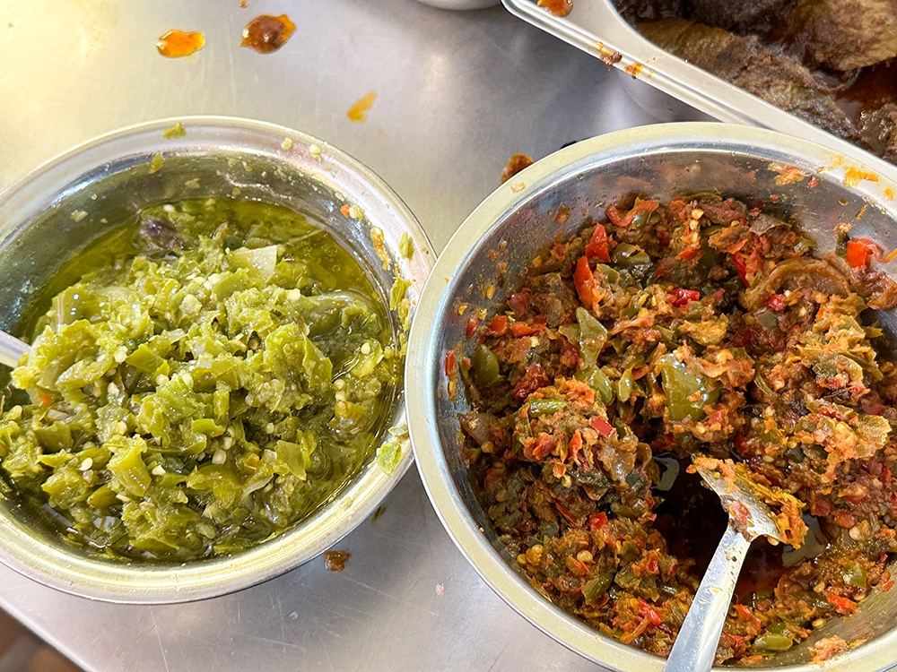 Grab a big spoonful of 'sambal' from the counter.