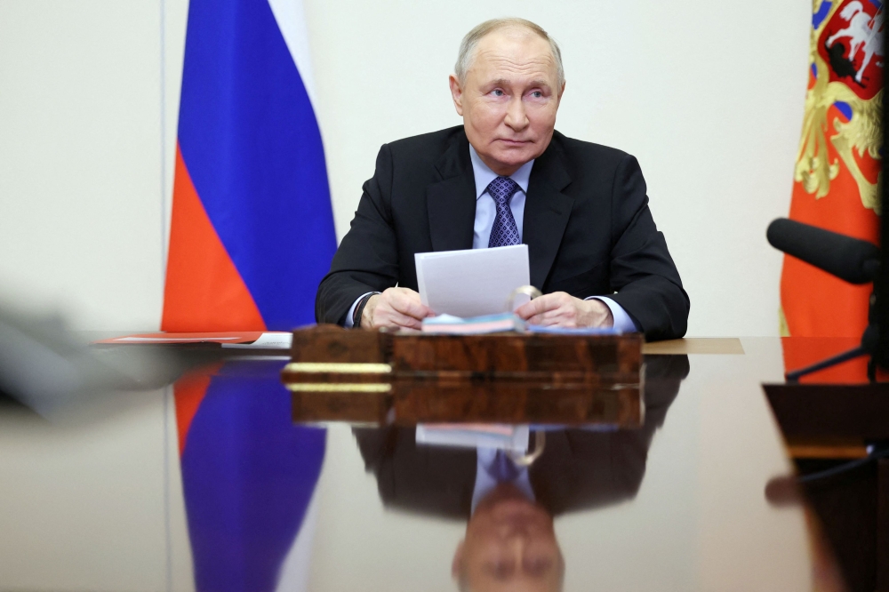 Russian President Vladimir Putin chairs a meeting with members of the Security Council via video link at the Novo-Ogaryovo state residence outside Moscow, Russia February 13, 2024. — Sputnik/Alexander Kazakov/Pool via Reuters pic