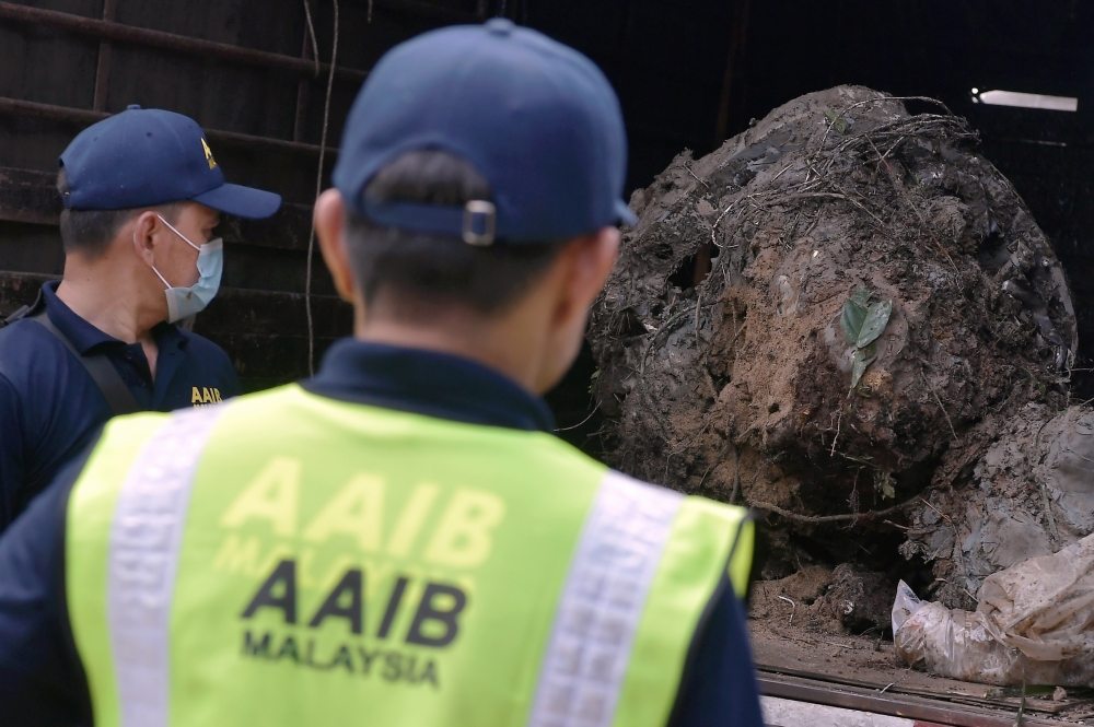 Members of the Air Accidents Investigation Bureau team move part of the wreckage of the BK 160 Gabriel light aircraft that crashed in Kampung Tok Muda in Kapar yesterday to be sent to a hangar in Subang for investigation during a survey at the scene February 14, 2024. — Bernama pic