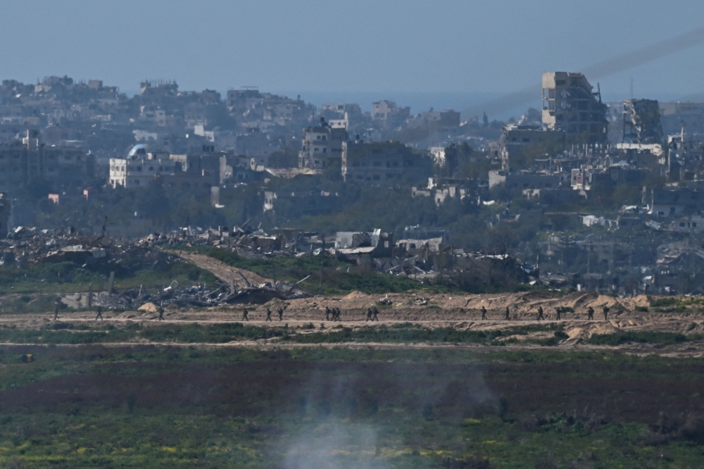 Israeli army patrol Gaza, amid the ongoing conflict between Israel and the Palestinian Islamist group Hamas, as seen from Israel, February 14, 2024. — Reuters pic