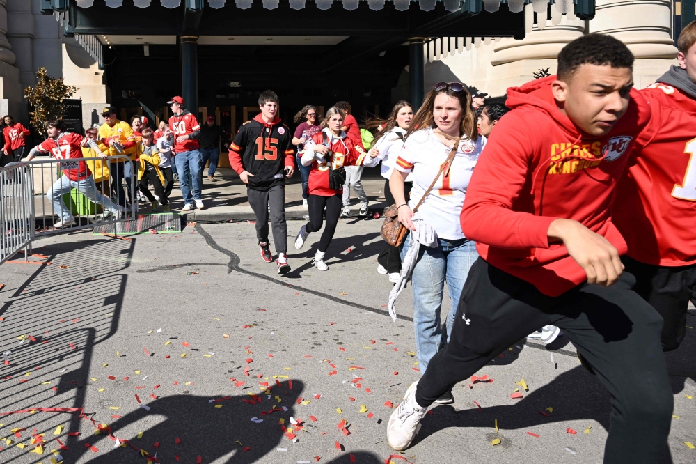 People flee after shots were fired at the Kansas City Chiefs’ Super Bowl victory rally. — AFP pic