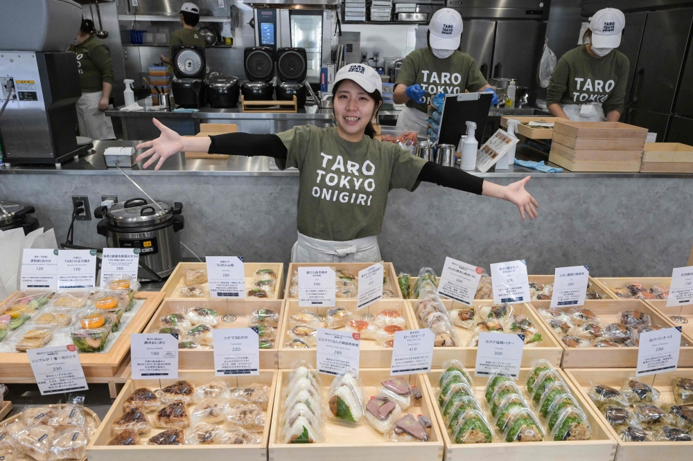 This photo taken on December 6, 2023 shows Miyuki Kawarada, the president of Taro Tokyo Onigiri, a shop specialising in Japanese rice balls, known as 