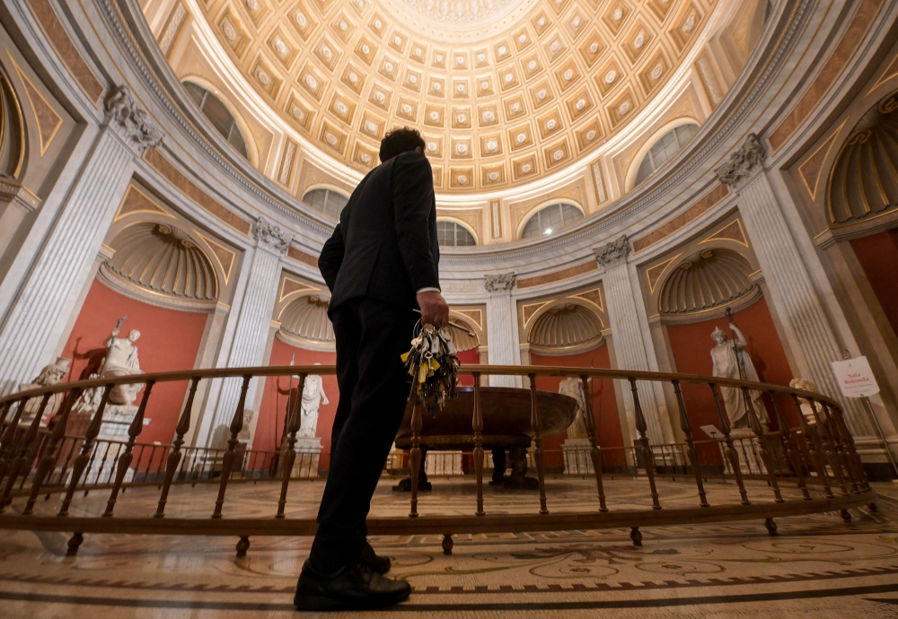 Gianni Crea, key keeper of the Vatican Museums, walks in the Round Hall during a private visit of the museums by night, early on February 13, 2024. — AFP pic
