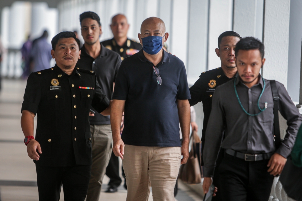 According to the charges, Fikri Abu Bakar (2nd, left), as the director of Fikri Rice Sdn Bhd, through his company’s staff, submitted 28 invoices, totalling more than RM8.9 million, to claim Trade Working Capital Financing Islamic financing facilities for the purchase of rice, to the agent of Agrobank Berhad. — Bernama pic 