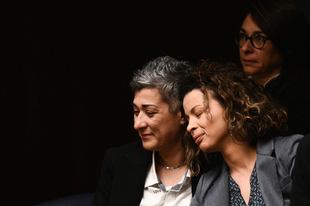 Visitors react after the parliamentary vote on same-sex marriage in Athens, on February 15, 2024. — AFP pic