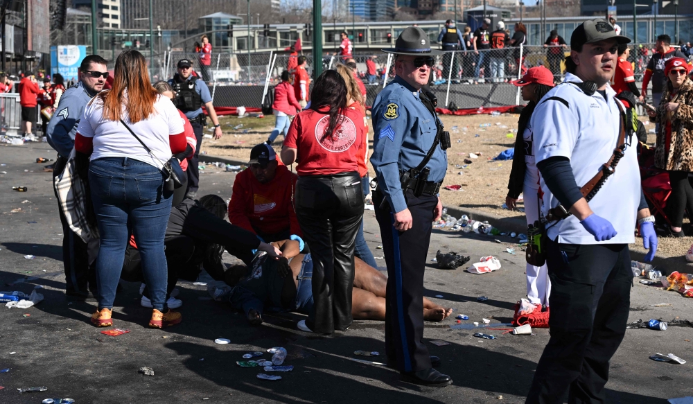 An injured person is helped near the Kansas City Chiefs' Super Bowl LVIII victory parade on February 14, 2024, in Kansas City, Missouri. — AFP pic