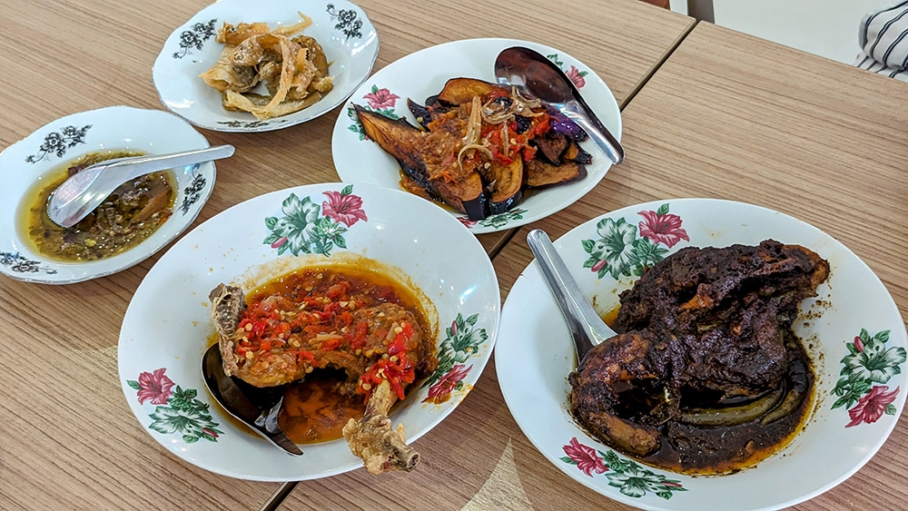 The spread at LAUK Ayam Kampung, clockwise from left to right: 'terung berlado', 'kerutuk ayam kampung', 'ayam kampung berlado', 'sambal hijau' and 'ikan masin'. – Pictures by Ethan Lau