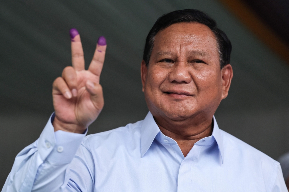 This photo taken on on February 14, 2024 shows Indonesia's presidential candidate Prabowo Subianto gesturing after casting his ballot to vote in Indonesia's presidential and legislative elections in Bogor, West Java. — AFP pic