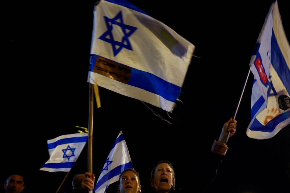 People take part in a protest against Israeli Prime Minister Benjamin Netanyahu's government amid the ongoing conflict between Israel and the Palestinian Islamist group Hamas, in Tel Aviv, Israel, February 10, 2024. — AFP pic