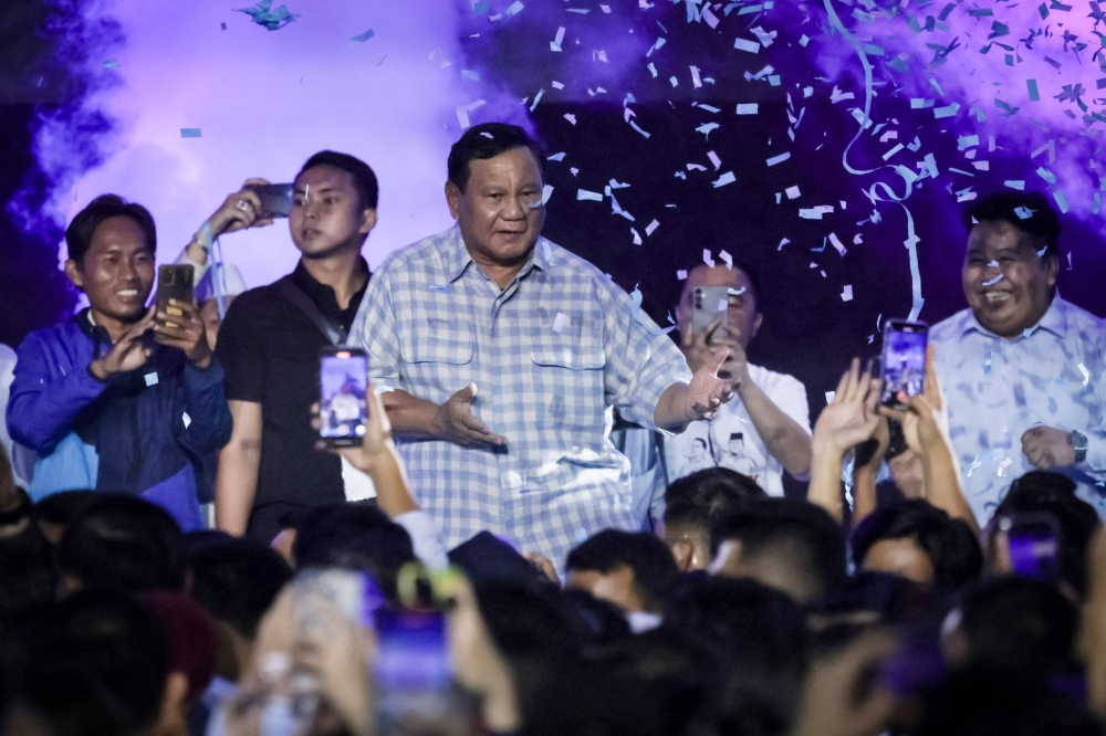 Presidential candidate and Indonesia's Defence Minister Prabowo Subianto dances on the stage during a gathering with supporters after polls closed in the country's presidential and legislative elections in Jakarta on February 14, 2024. — AFP pic