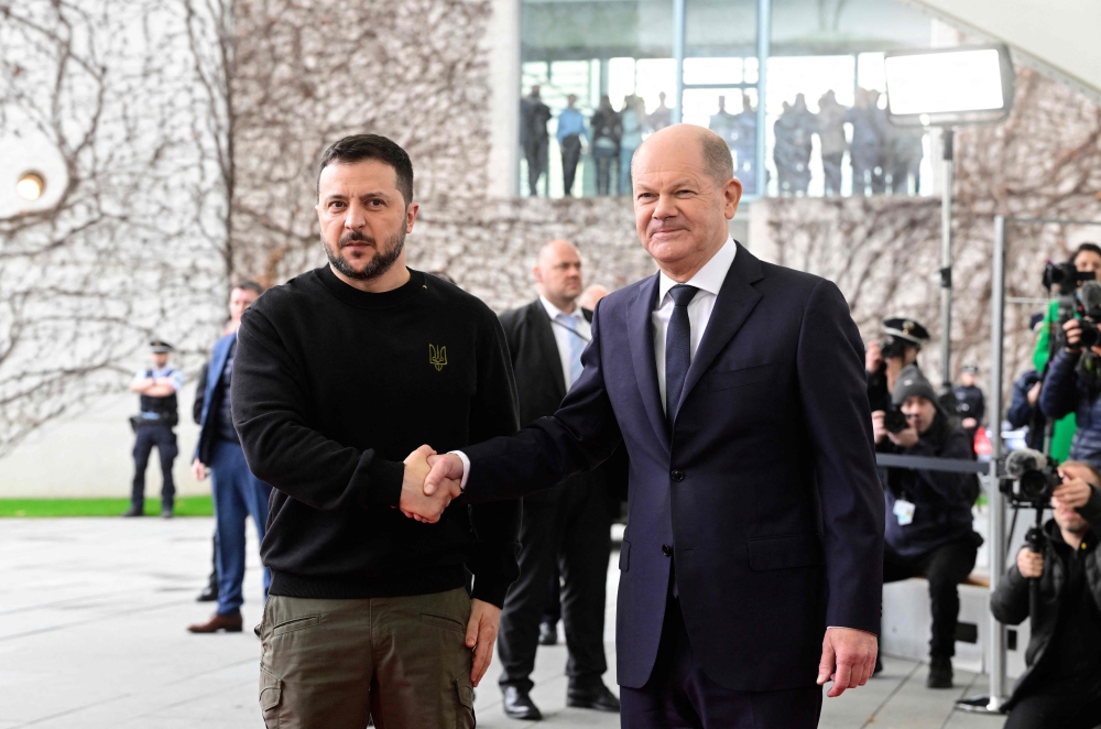 German Chancellor Olaf Scholz (right) shakes hands with Ukraine's President Volodymyr Zelensky as he arrives for a visit at the Chancellery in Berlin on February 16, 2024. ― AFP pic