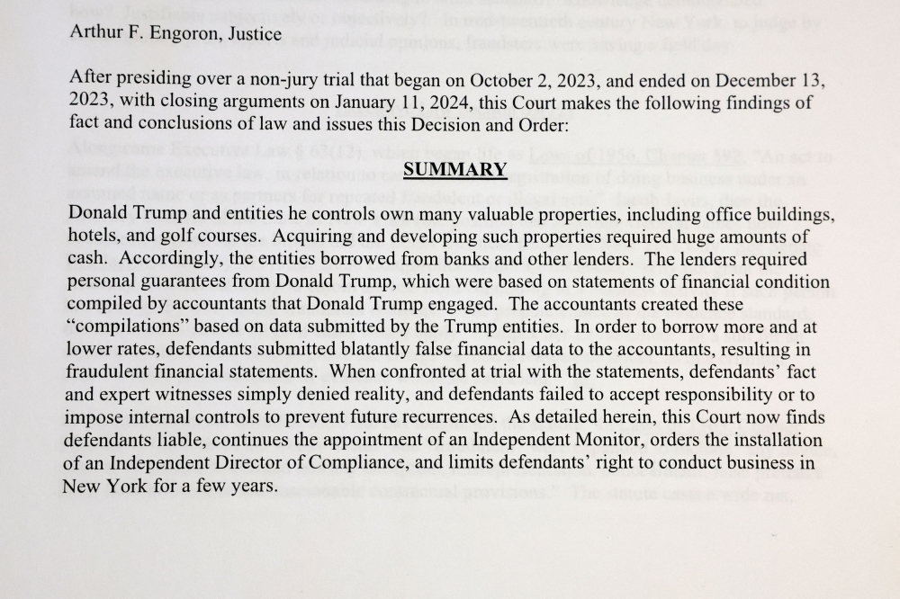 A printed page from Judge Arthur Engoron’s ruling against former US President Donald Trump ordering him to pay US$354.9 million and barring him from doing business in New York State for three years, is photographed in New York February 16, 2024. ― Reuters pic