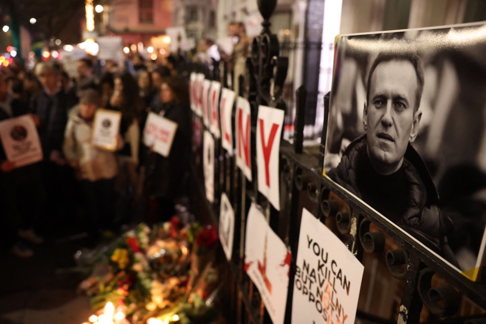 People stand with placards outside the Russian Embassy in London on February 16, 2024, following the news of the death of Russian opposition leader Alexei Navalny. ― AFP pic