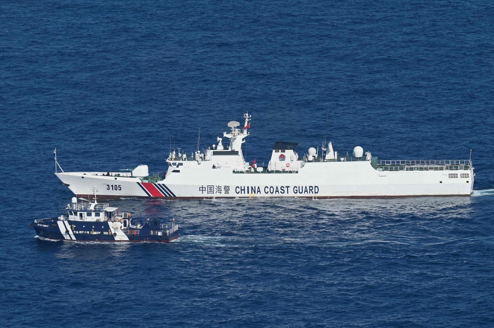 This photo taken on February 15, 2024, shows an aerial view of China Coast Guard vessel (upper) shadowing the BRP Datu Tamblot (lower) during a mission to bring supplies and assistance to the fishermen in Scarborough Shoal in the disputed South China Sea. ― AFP pic