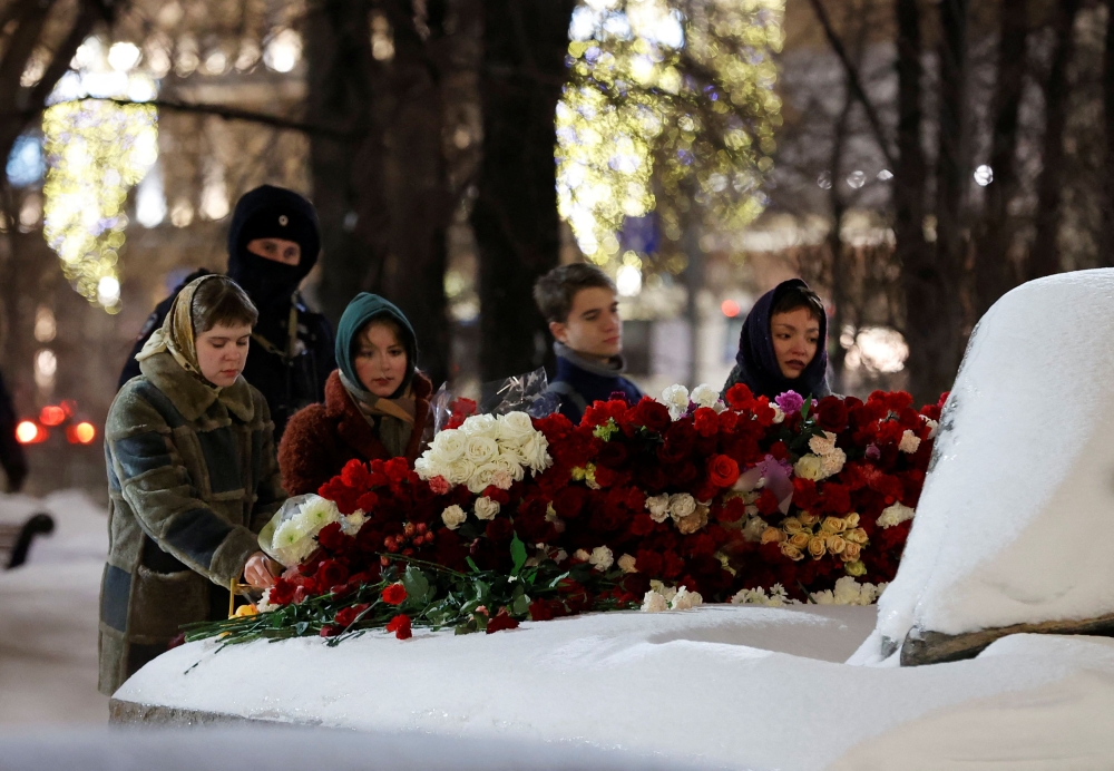People lay flowers at the monument to the victims of political repressions following the death of Russian opposition leader Alexei Navalny, in Moscow, Russia February 16, 2024. ― Reuters pic