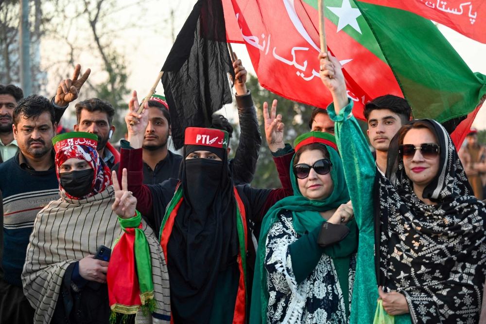 File photo of supporters of Imran Khan’s Pakistan Tehreek-e-Insaf (PTI) party blocking Peshawar to Islamabad highway as they protest against the alleged skewing in Pakistan’s national election results, in Peshawar on February 12, 2024. ― AFP pic