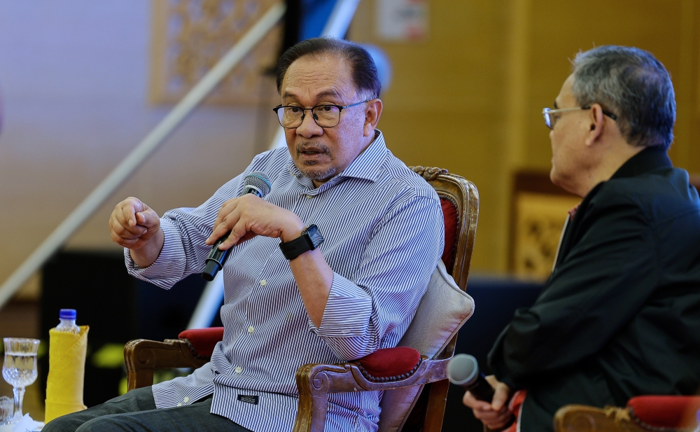 Prime Minister Datuk Seri Anwar Ibrahim speaks at a dialogue session in conjunction with the closing ceremony of a two-day retreat involving press secretaries and corporate communications heads in Putrajaya, February 17, 2024. — Bernama pic