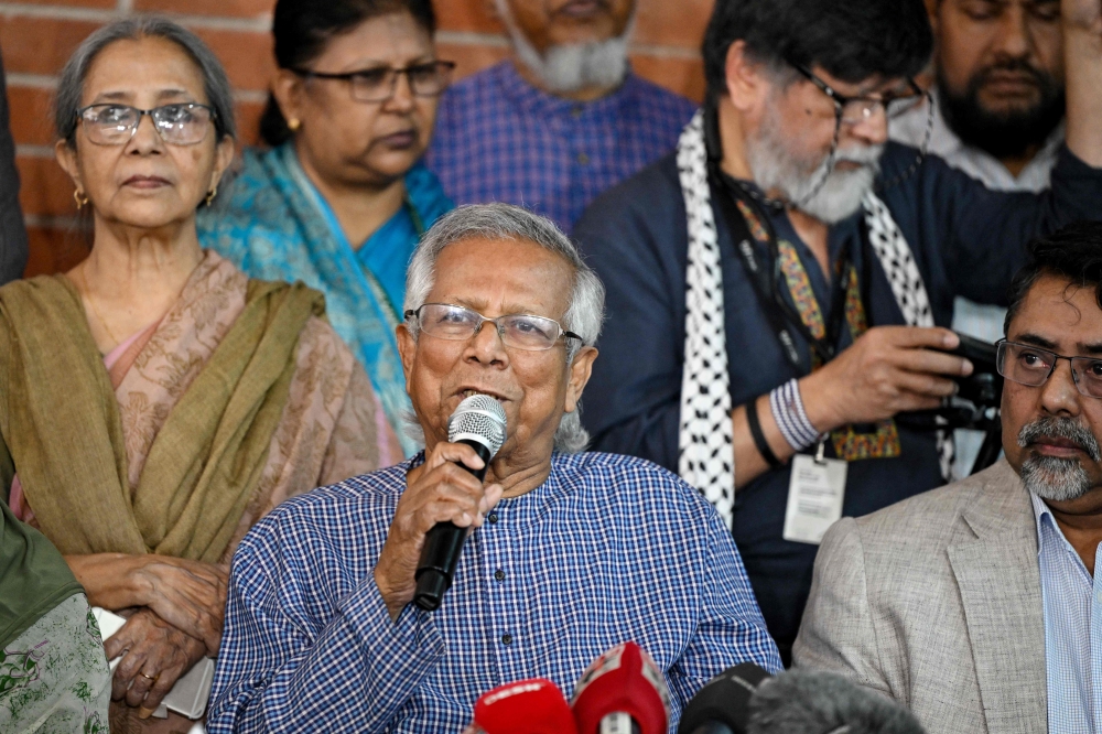 Bangladesh Nobel peace laureate Muhammad Yunus (centre) addresses a press conference at his office in Dhaka on February 15, 2024. ― AFP pic
