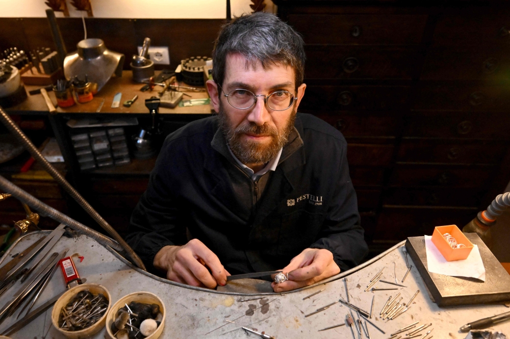 Goldsmith Tommaso Pestelli, poses in his new workshop after he was forced to leave the historic one, in Florence, on February 15, 2024. — AFP pic