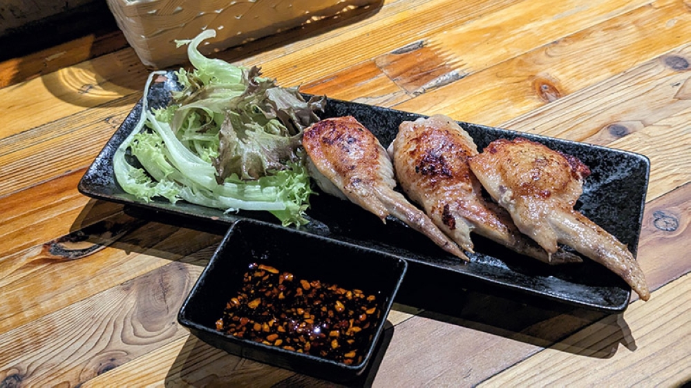 Grilled Chicken Wing Gyoza — the platonic ideal of drinking food.