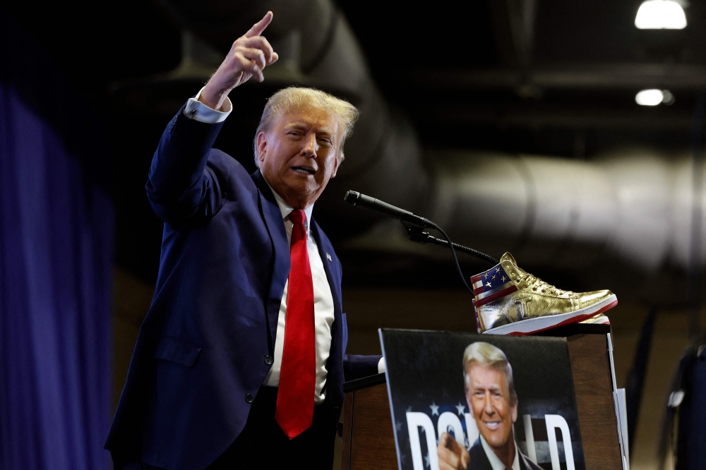 Former president Donald Trump at Sneaker Con at the Philadelphia Convention Centre on February 17, 2024, where he launched his own sneaker brand — gold-topped with American flag logos. — AFP pic