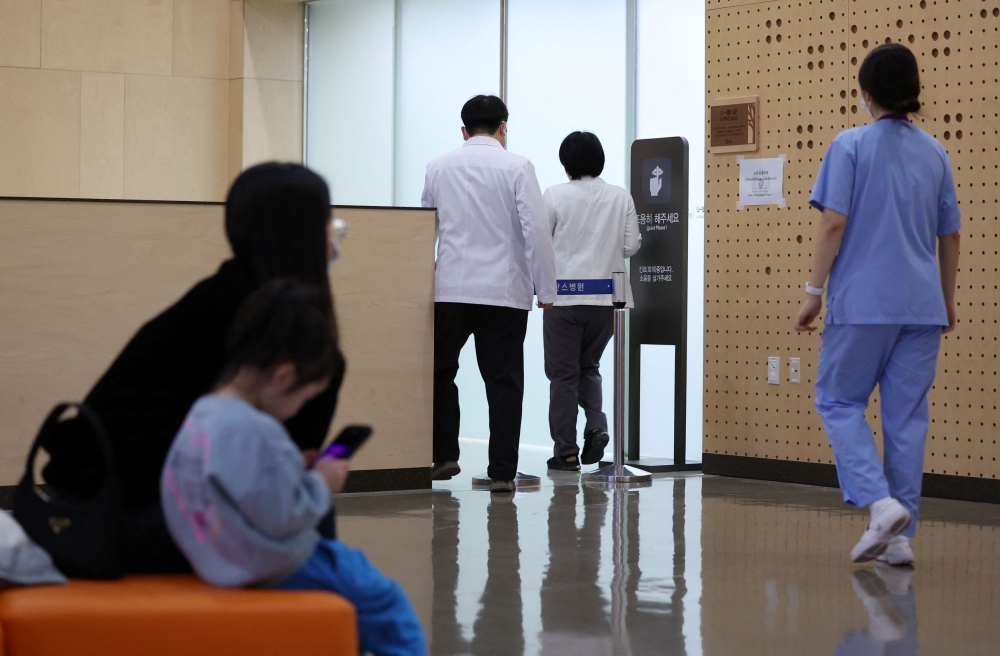 Medical workers walk at a hospital in Seoul, South Korea, February 19, 2024. — Yonhap via Reuters pic 