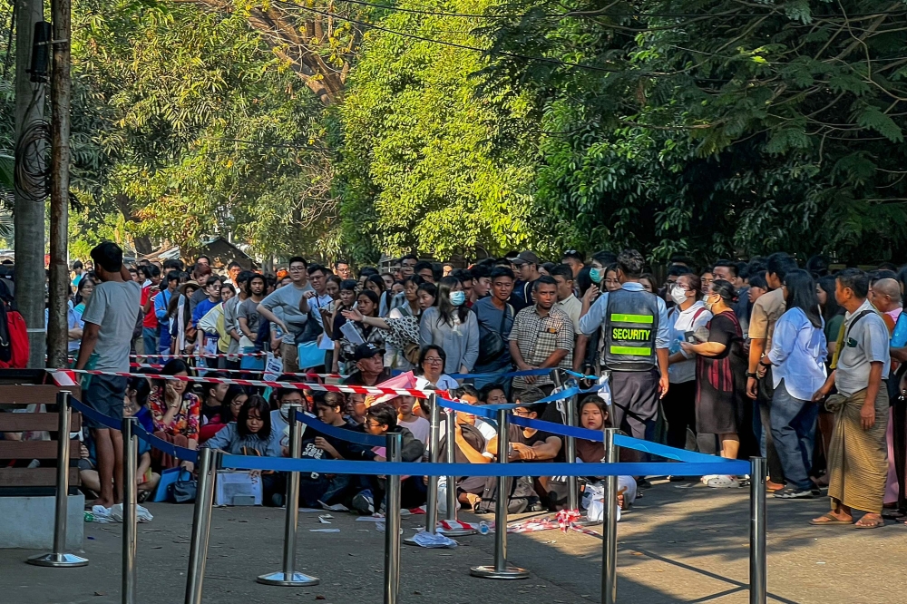 People gather outside the embassy of Thailand in Yangon to get visas on February 16, 2024. — AFP pic
