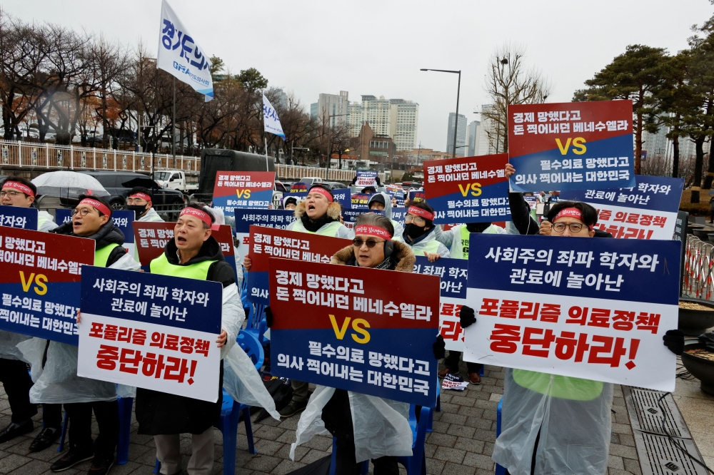 Doctors and Medical workers take part in a protest against a plan to admit more students to medical school, in front of the Presidential Office in Seoul, South Korea, February 21, 2024. — Reuters pic