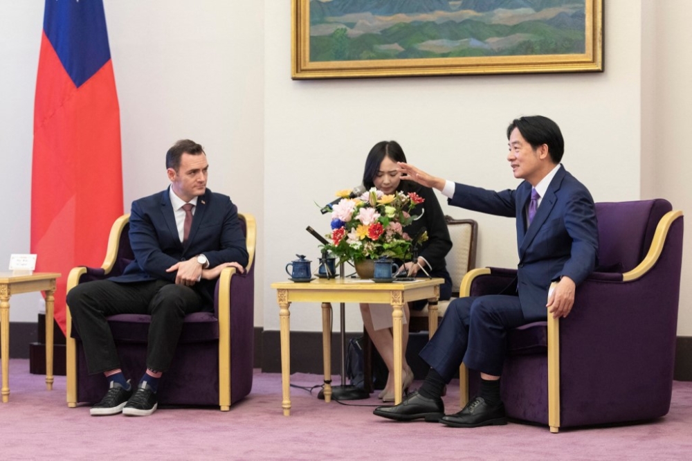 This handout picture taken and released by the Taiwan Presidential Office on February 22, 2024 shows Mike Gallagher of the US House of Representatives (left) listening to Taiwan's Vice President Lai Ching-te at the Presidential Office in Taipei. — AFP pic