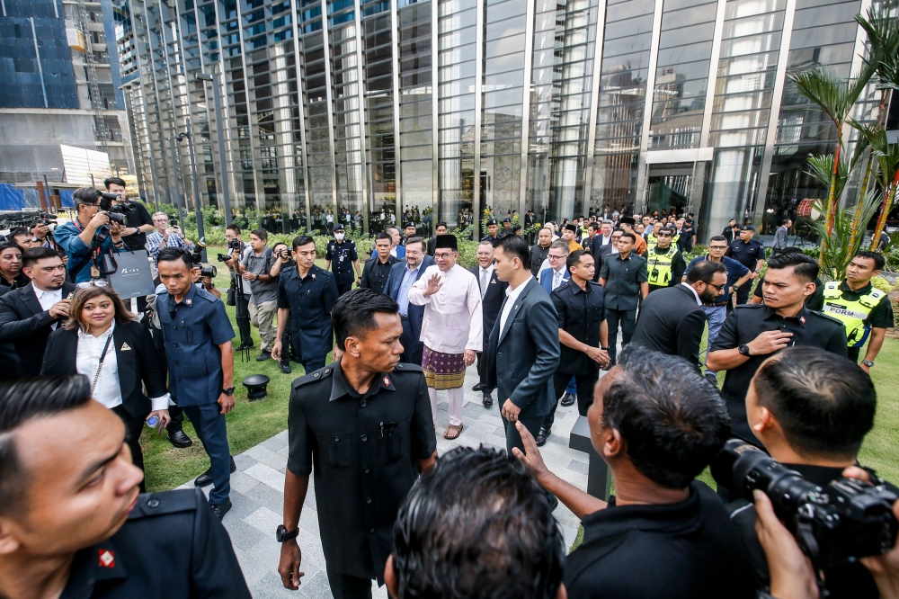 Prime Minister Datuk Seri Anwar Ibrahim greets people during the launch of the Tun Razak Exchange International Financial Hub in Kuala Lumpur February 23, 2024. — Picture by Hari Anggara