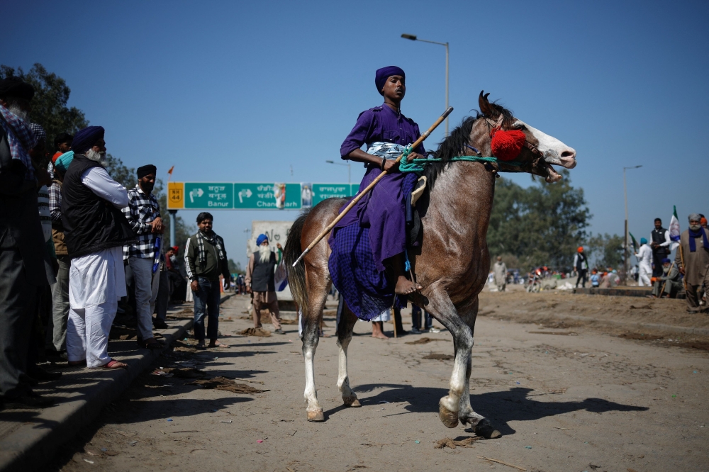 Thousands of protesting Indian farmers facing off with security forces have come under the protection of the Nihang Sikhs, a warrior sect dating back to the 1600s distinguished by their ink-blue robes and ancient weapons such as swords and spears. — Reuters pic