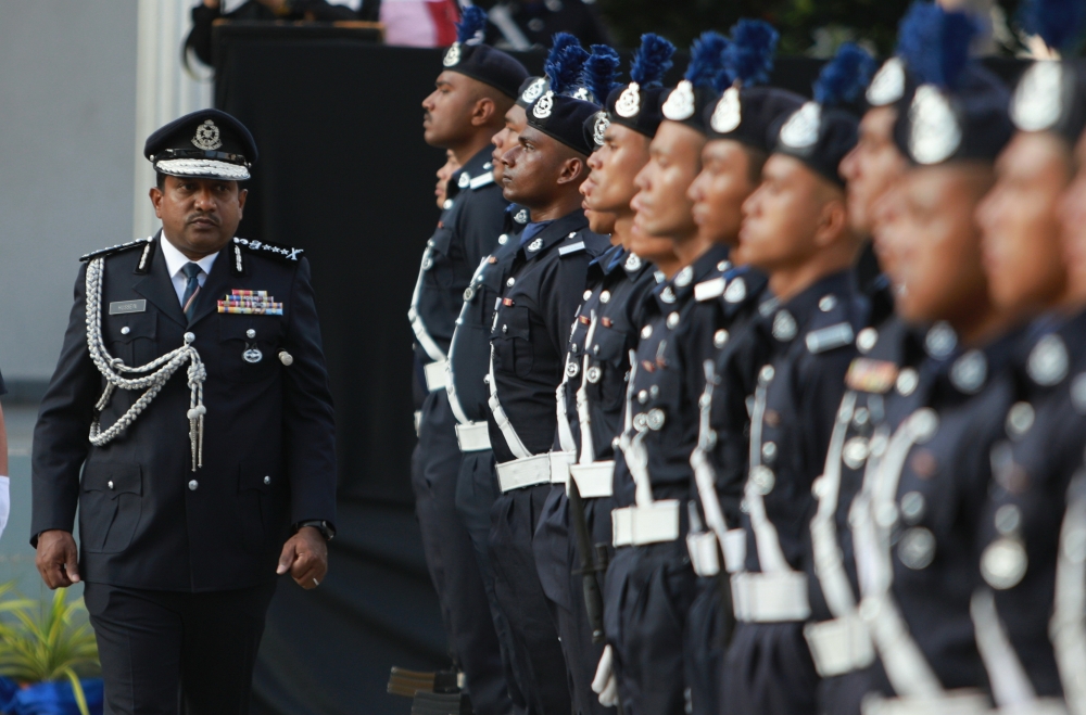 Selangor police chief Datuk Hussein Omar Khan inspects the guard of honour at the handing over of duties of Petaling Jaya district police chief in Petaling Jaya, February 23, 2024. — Bernama pic 
