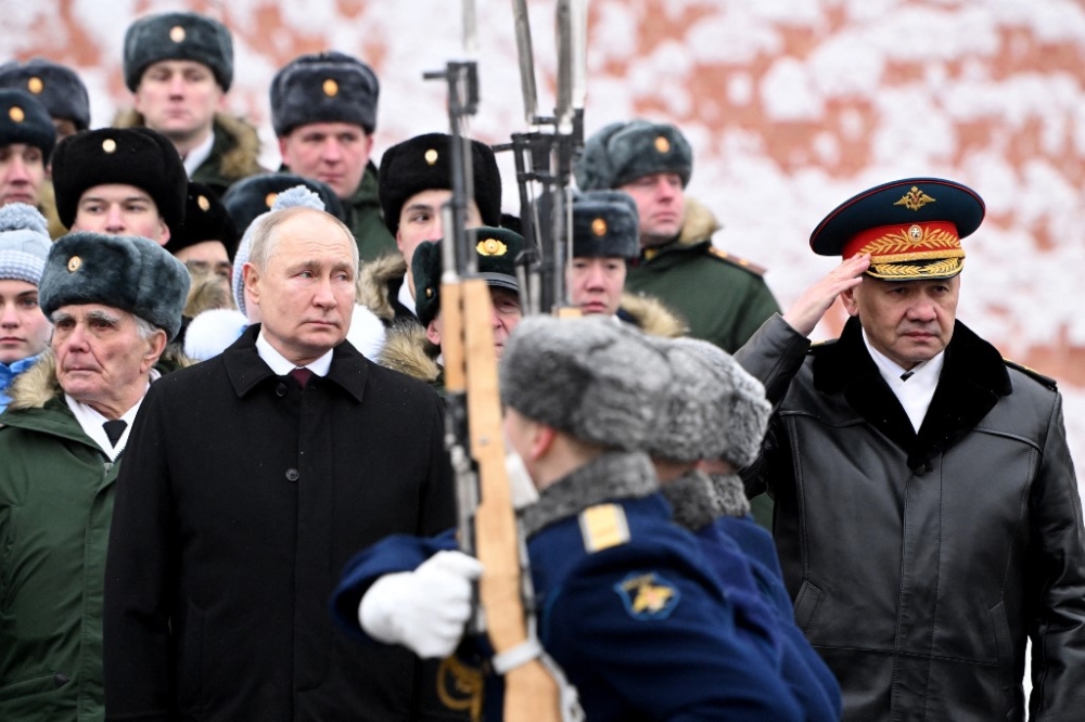 In this pool photograph distributed by Russian state agency Sputnik, Russia's President Vladimir Putin, accompanied by Defence Minister Sergei Shoigu, attends a wreath-laying ceremony at the Tomb of the Unknown Soldier by the Kremlin Wall to mark the Defender of the Fatherland Day in Moscow on February 23, 2024. — AFP pic